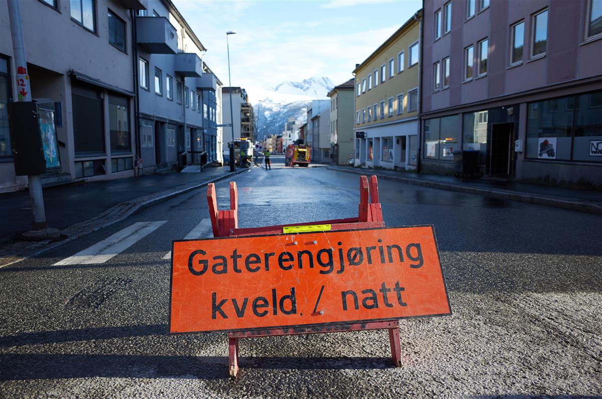 Skilt med teksten Gaterengjøring kveld/natt. Bildet er tatt i Gate 2, og viser gaten med Ofoten brann i bakgrunnen som spyler gaten. - Klikk for stort bilde